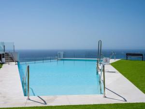 a large swimming pool with a view of the ocean at Luxury 2 Bedrooms Apartment Bayview Hills Nerja in Torrox