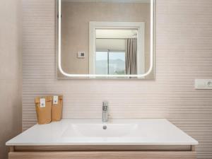 a bathroom with a white sink and a mirror at Luxury 2 Bedrooms Apartment Bayview Hills Nerja in Torrox