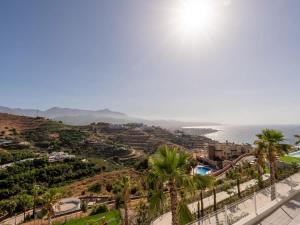 a view of a resort with palm trees and the ocean at Luxury 2 Bedrooms Apartment Bayview Hills Nerja in Torrox