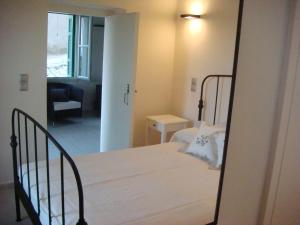 1 dormitorio con 1 cama con espejo. en KARMI Apartments Stenies Andros, en Steniaí