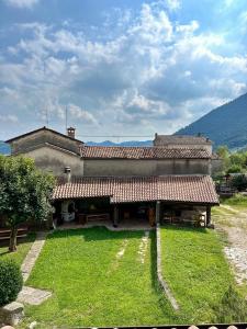 a large building with a grass yard in front of it at Da Nonna Laura in Follina
