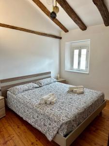 a bedroom with a bed with two towels on it at Da Nonna Laura in Follina
