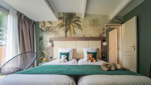 a bedroom with two beds with stuffed animals on them at Quintessia in Orvault