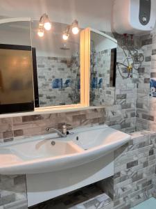 a bathroom with a sink and a mirror at Hôtel YABISSO in Lomé +115 photos