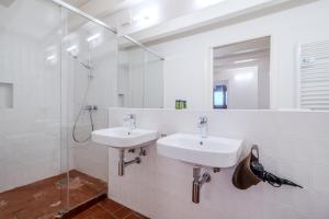 a bathroom with two sinks and a shower at Flateli Santa Clara 22 in Girona +17 photos