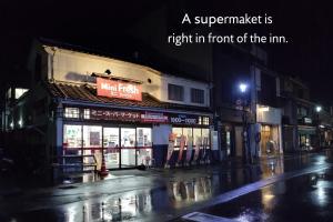 a supermarket is right in front of the im at night at Yoshiharu in Toyooka