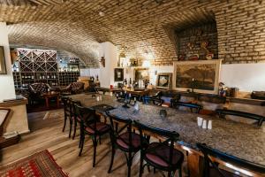 a bar in a restaurant with chairs and tables at Artist hotel in Subotica