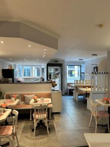 a restaurant with tables and chairs and a counter at Hotel Jägerhof in Wiesbaden
