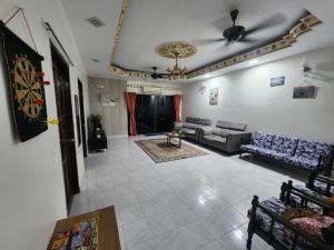 a living room with couches and a ceiling at Raintown RR Homestay in Kamunting