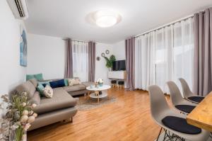 a living room with a couch and a table at House with pool and whirlpool in Sarići