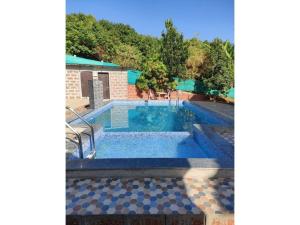 a swimming pool in a house with at Green Leaf Mini Resort in Mahabaleshwar
