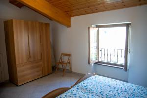 a bedroom with a bed and a window at Appartamenti Bonaventura in Tignale +49 photos