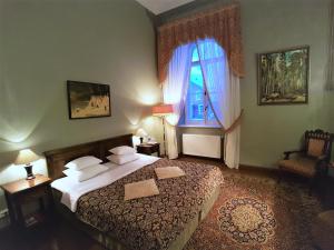 a bedroom with a large bed and a window at Birinu Castle in Bīriņi +90 photos