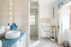 a white bathroom with a sink and a mirror at B&B Des Histoires d'Anges - Côté Jardin - Accueil Vélo in Tournus +78 photos