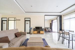 a living room with a couch and a table at Spacious Tropical Villa with Pool and Bfast in Sleman
