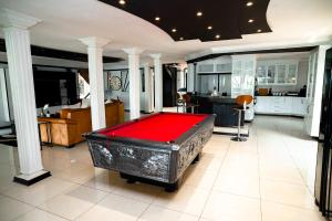 a large room with a pool table in the middle at The View Guesthouse in Nelspruit