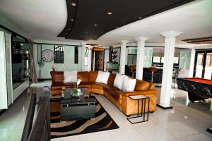a living room with a couch and a pool table at The View Guesthouse in Nelspruit
