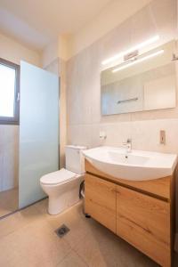 a bathroom with a sink and a toilet at Arangia Garden Maisonette in Kaká Pinári +23 photos