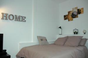 a bedroom with a bed with two pillows on it at Le Cosy Musette - Rue Piétonne in Dijon