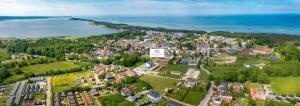 an aerial view of a town next to a body of water at Błękitna Fala Resort in Dąbki
