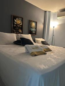 a large white bed with two pillows on it at Flat JK 101 in Juazeiro do Norte