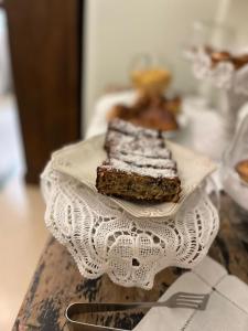 a plate with a piece of cake on a table at Palazzo Gallo Resort in Gallipoli