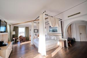 a bedroom with a white bed with a canopy at Hotel Hirschen in Freiburg-Lehen in Freiburg im Breisgau