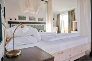 a bedroom with two beds and a lamp on a table at Hotel Hirschen in Freiburg-Lehen in Freiburg im Breisgau