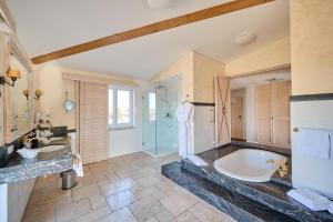 a large bathroom with two sinks and a tub at Hotel Hirschen in Freiburg-Lehen in Freiburg im Breisgau +104 photos