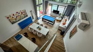 an overhead view of a living room with a table and chairs at Gaia Pool Villa Khao Yai in Ban Bung Toei