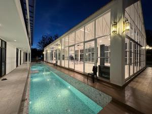 a house with a swimming pool next to a building at The Rubber Escape, Melaka in Malacca