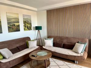 a living room with a couch and a table at Apartament Emilia in Koszalin