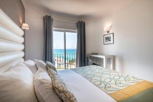 a bedroom with a bed with a view of the ocean at Vila Sao Vicente Boutique (Adults Only) in Albufeira +97 photos