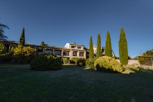 a large house with trees in front of it at Hotel Bellerive in Rasteau