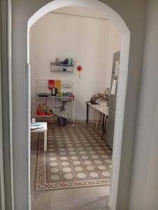 a hallway with an archway into a kitchen with a table at Sunset hostel Palermo in Palermo