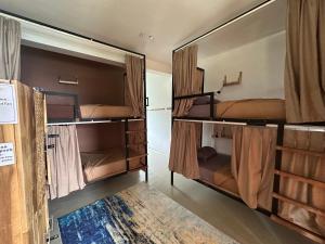 a group of bunk beds in a room at Beyond Nomad Luxury Hostel in Ella