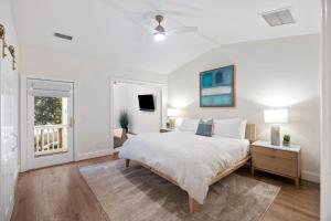 a white bedroom with a bed and a window at 3026 Fairway One in Seabrook Island +68 photos