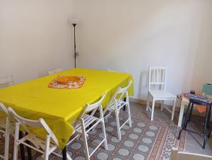 a yellow table with white chairs in a room at Sunset hostel Palermo in Palermo +15 photos