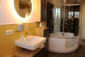 a bathroom with a sink and a shower and a tub at Ferienwohnungen Augustinerhof in Quedlinburg