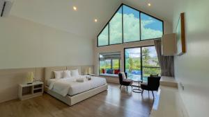 a bedroom with a bed and a large window at Gaia Pool Villa Khao Yai in Ban Bung Toei +136 photos