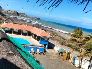 a house with a swimming pool next to the beach at Amerie Rae Resort in Bangui