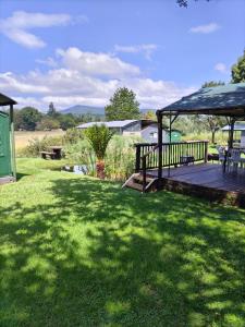 a wooden deck with a gazebo in a yard at Sabie River Camp in Sabie