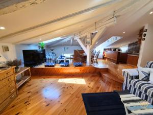 a large living room with a couch and a tv at Apartment Blue Whale in Piran