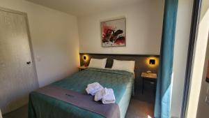 ein Schlafzimmer mit einem Bett, auf dem Handtücher liegen in der Unterkunft Hotel Oasis-Dream Holidays - La Petite France in San Bernardino