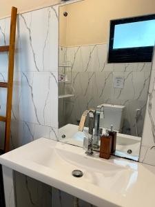 a bathroom with a sink and a mirror at Beyond Nomad Luxury Hostel in Ella +71 photos