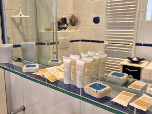 a glass shelf with someental products on it at Apartment Blue Whale in Piran +29 photos