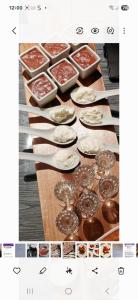 a table with many different types of food on it at "Sous Le Même Toit" "CHAMBRE FAMILIALE CHEZ L' HABITANT" in Rendeux