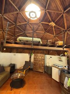 a living room with a bed on a loft at Pink Elephant in Lorca