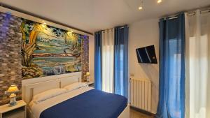 a bedroom with a painting on the wall and a bed at B&B Triskèles in Giardini Naxos