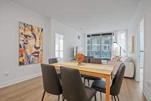 a dining room with a table and some chairs at Panoramic Lakeview Resort Living 3BDR with Gym, Pool, Free parking in Toronto